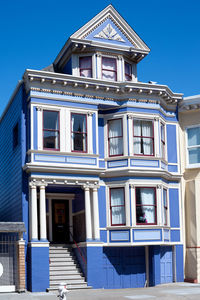 Low angle view of building against clear blue sky