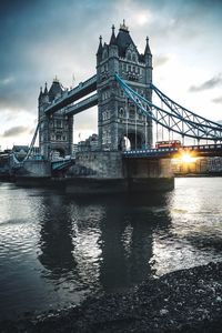 View of bridge over river against cloudy sky