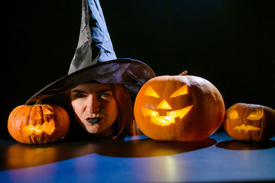 Jack o lantern on table against black background