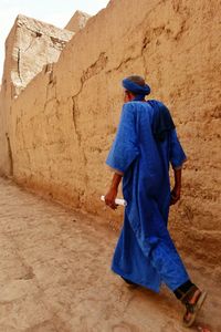 Full length of woman standing in desert