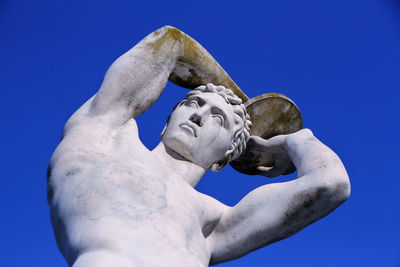 Low angle view of statue against clear blue sky