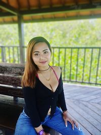 Portrait of young woman sitting outdoors