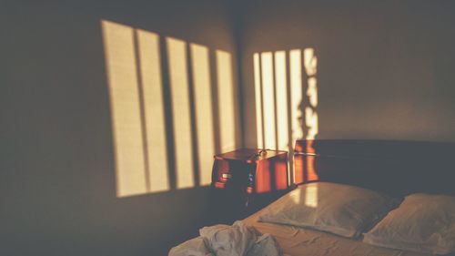 Sunlight falling on wall in bedroom at home