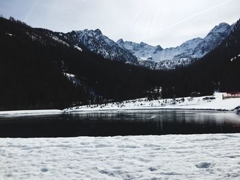 Scenic view of lake by snowcapped mountains