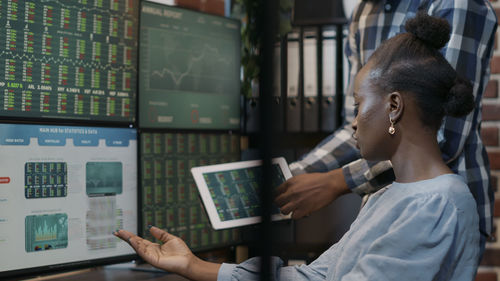 Female stock trader brainstorming at office