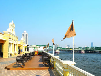 Terrace along river with buildings in background