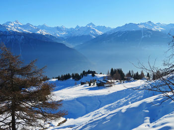 Scenic view of snowcapped mountains against sky