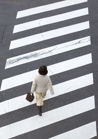 Full length of woman standing by railing