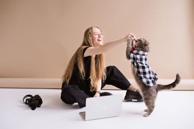 Side view of woman using laptop at home