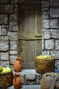 Close-up of basket against stone wall