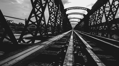 Surface level of railroad tracks against sky