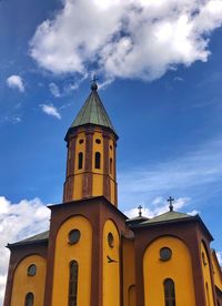 Low angle view of church and building against sky