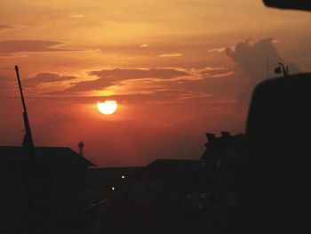 Silhouette buildings against sky during sunset