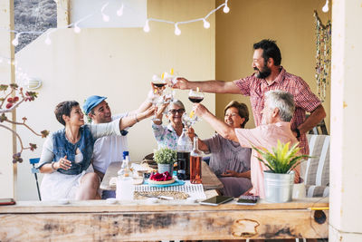 Cheerful family toasting drink at home 