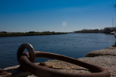 Close-up of lake against blue sky