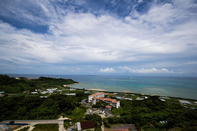 High angle view of town by sea against sky