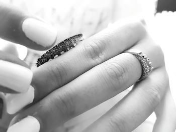 Close-up of hand holding lizard