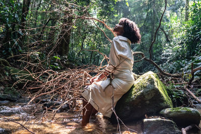 Woman sitting in forest