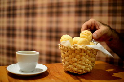 Close-up of hand holding coffee cup