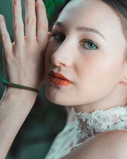 Close-up portrait of woman with hands