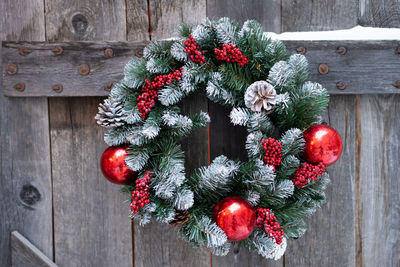 Christmas wreath hanging on old wooden door. winter holidays