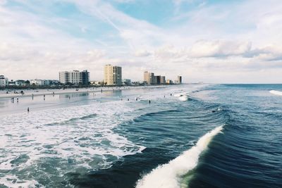 Scenic view of sea and buildings against sky