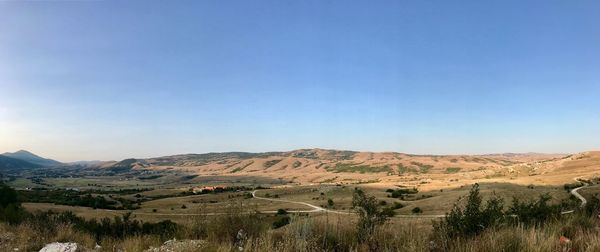 Scenic view of mountains against clear blue sky