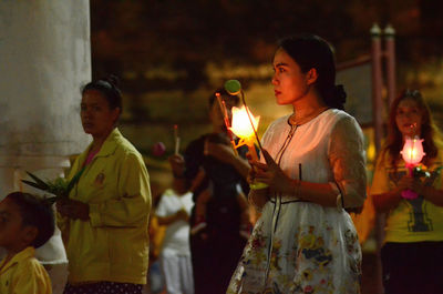 Group of people at illuminated temple