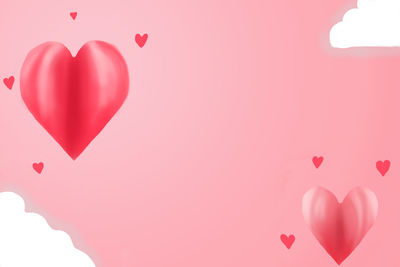 Close-up of heart shape over pink background