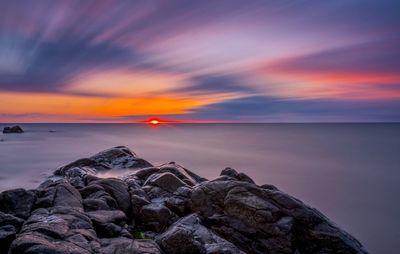 Scenic view of sea against sky at sunset