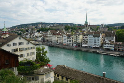 High angle view of townscape by river in city