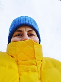 Portrait of woman covering face covered with jacket