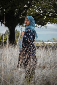 Side view of woman standing on field