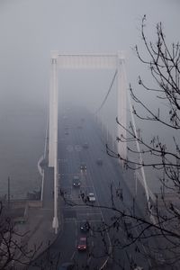 High angle view of cars moving on bridge during foggy weather