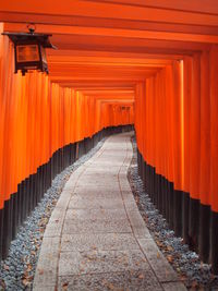 Footpath amidst torii gates at fushimi inari shrine