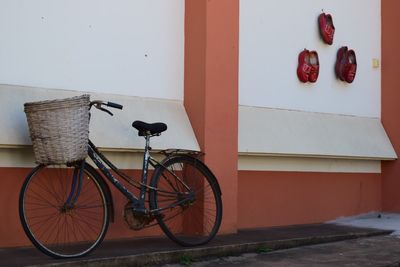 Side view of parked bicycle against the wall