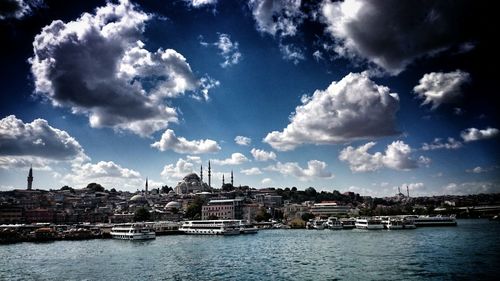 Panoramic view of sea and cityscape against sky