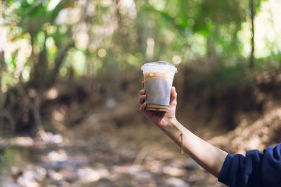 Cropped hand of woman holding drink