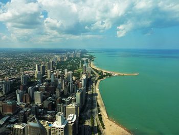 High angle shot of cityscape against calm sea