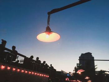 Low angle view of illuminated lanterns against clear sky