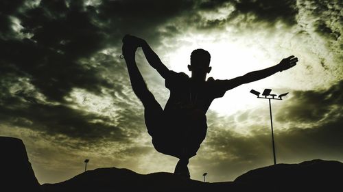 Low angle view of silhouette man against sky at sunset