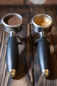 Photo of coffee, pre and post grinded on wooden table