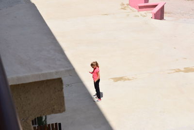 Full length of woman standing by railing
