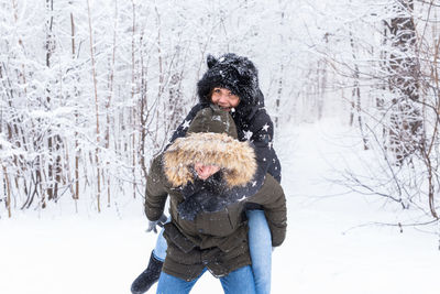 Woman with dog in snow