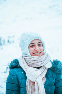 Portrait of a smiling young woman in snow