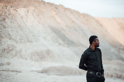 Full length of young man looking away