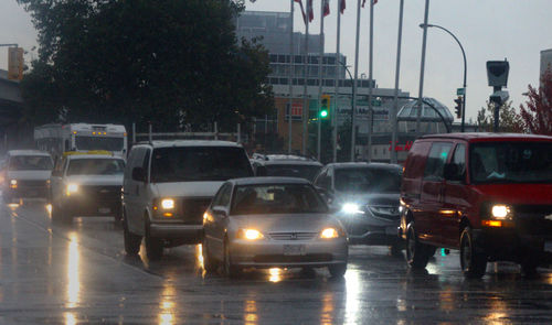 Cars on illuminated city street at night