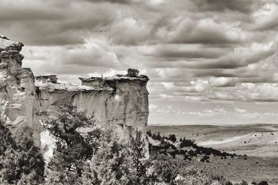 Rock formations on landscape against sky