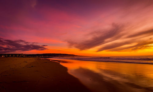 Scenic view of dramatic sky over sea during sunset