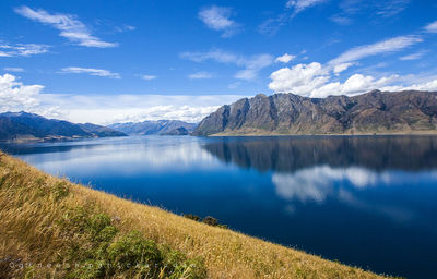 Scenic view of lake against sky at night